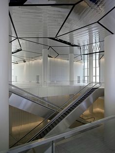 an escalator in a building with metal railings