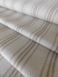 three different types of fabric on top of each other, one in beige and the other in white