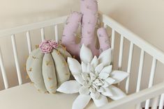 a white crib with pink and green decorations