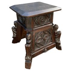 an old wooden table with carvings on the top and bottom, against a white background