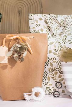 a brown paper bag sitting on top of a table next to scissors and other items