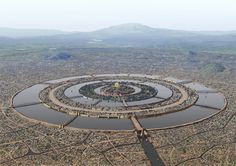 an aerial view of a circular structure in the middle of a city