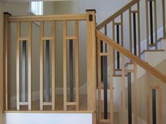 an empty room with wooden stairs and white walls