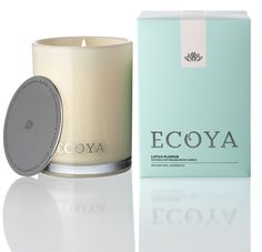 an ecoya candle next to a pink box on a white surface with the words ecoya written across it