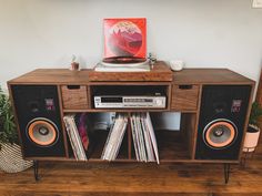 an entertainment center with record players and records