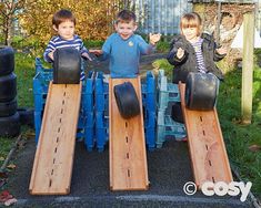 three children playing with wooden sleds in the yard