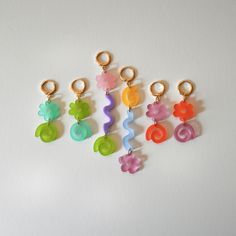 These super fun mismatched earrings are bright and playful. They come in two color-ways. gold or rhodium plated stainless steel huggie hoops acrylic 2 in x .5 in Playful Green Jewelry With Matching Earrings, Playful Hoop Earrings As Gift, Trendy Resin Earrings, Trendy Small Hoop Plastic Earrings, Colorful Handmade Playful Earrings, Cheap Playful Green Earrings, Earthcore Aesthetic, Playful Plastic Dangle Jewelry, Goofy Earrings