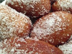 some sugar covered doughnuts are in a bowl