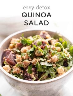 a white bowl filled with quinoa salad on top of a table