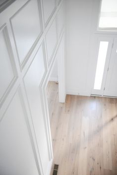 an empty room with wooden floors and white walls, is seen from the top down