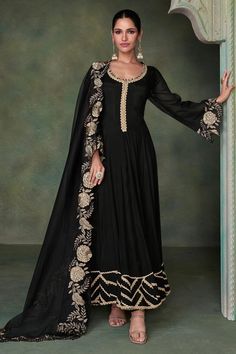 Premium Silk Black Anarkali Gown with Heavy Embroidered Dupatta | Luxury Ethnic Wear Elevate your wardrobe with this stunning Black Anarkali Gown, crafted from premium silk and paired with a heavily embroidered dupatta. Exquisite Silk Elegance: This floor-length Anarkali gown is made from rich, lustrous silk that drapes beautifully, exuding timeless grace and sophistication. The luxurious fabric ensures a smooth, elegant flow with every step, making it perfect for special occasions. Key Features Organza Dress Indian, Women Indian Wear, Black Organza Dress, Black Anarkali, Silk Anarkali, Gown With Dupatta, Anarkali Gown, Utsav Fashion, Organza Dress