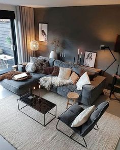 a living room filled with lots of furniture next to a large glass wall window,