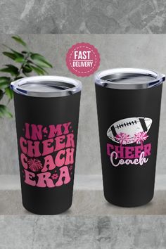 two black tumblers with pink and white designs on them, one has an american football