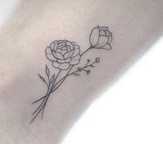 a small flower tattoo on the wrist