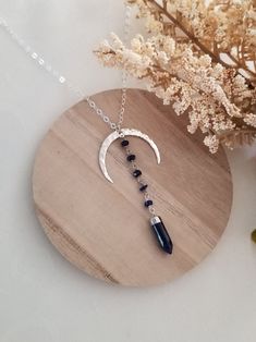 This unique pendant necklace will complete any outfit for day or night. The moon is a symbol of change and regeneration. Lapis Lazuli, the stone of wisdom. Helps us to reconnect with our inner self. Lapis is used to form stronger bonds of friendship and generate inner peace and honesty. A hammed crescent Moon is accented with tiny Lapis Lazuli stones that are wire wrapped together and joined to a Lapis Spike stone. This unique pendant is suspended from shimmering Sterling Silver chain in your ch Bohemian Moon Shaped Jewelry For Meditation, Mystical Blue Pendant Necklace, Spiritual Crescent Moon Phase Necklaces, Spiritual Moon-shaped Festival Jewelry, Spiritual Crescent Moon Phase Crystal Necklace, Spiritual Crescent Moon Phase Necklace, Crescent Moon Phase Crystal Necklaces For Jewelry Making, Bohemian Moon Phase Necklace In Sterling Silver, Spiritual Dangle Necklaces With Moon Charm