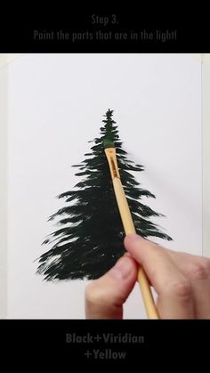 someone is painting a pine tree with black - and - yellow paint on white paper