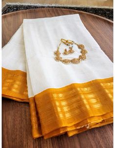 Introducing silk Cotton Gadwals for those looking to add a new variation to silk sarees to your handloom collection. The saree's body is pristine white cotton. The striking honey pallu and border are silk. Fall/Pico is NOT done for this saree. NO Blouse. Jewelry is for display purposes only. Minimum color variations are expected due to high-resolution camera quality. White Slub Silk Dupatta, White Slub Silk Anarkali Dupatta, White Anarkali Slub Silk Dupatta, Off White Cotton Silk Traditional Wear, White Cotton Silk Traditional Wear For Festive Season, White Slub Silk Dupatta With Embroidered Border, Gold Cotton Silk Dupatta With Embroidered Border, Unstitched White Cotton Silk Traditional Wear, White Slub Silk Bollywood Dupatta