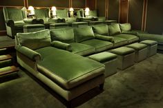 a green couch sitting in the middle of a room