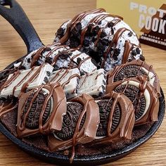 an oreo cookies and cream desert on a plate with chocolate drizzles