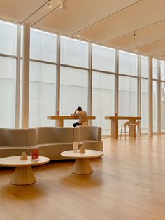 a person sitting on a couch in an empty room