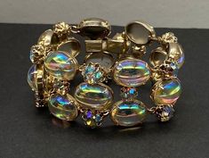 "Beautiful Rare Art Deco Estate Vintage Signed Vendome Large AB, Aurora Borealis Cabochon Crystal Bracelet nice and chunky pre/owned condition measures with normal wear 7.5\" length by 1 1/4\" width perfect to add in your collection." Luxury Artisan Bracelets With Cabochon, Luxury Ornate Cabochon Bracelets, Bracelet Vintage, Crystal Bracelet, Aurora Borealis, Chain Link Bracelet, Crystal Bracelets, Vintage Signs, Link Bracelets