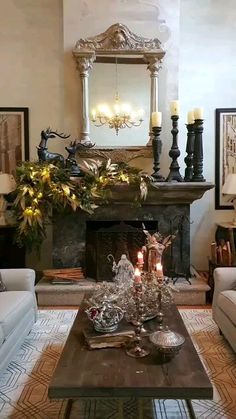 a living room filled with furniture and a fire place in front of a mirror on the wall