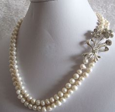 "Double strand pearl crystal brooch necklace, pearl necklace with brooch, diamond sparkle pearl necklace, wedding necklace, choker. Flower, Floral Motif Statement Wedding Bridal Necklace Art Deco Gatsby style! Crystal brooch 100% Natural Freshwater Pearl necklace Swarovski for Gatsby Wedding, Party or just for dressing up! This is a beautiful, classic, elegant necklace Elegant Bridal Wedding Jewelry 5-7mm Genuine Freshwater Cultured White Pearl Crystal Flower Statement Double 2 Row 18-19\" Stran Beaded Akoya Pearl Wedding Jewelry, Single Strand Akoya Pearl Necklace For Weddings, Akoya Pearl Beaded Necklace For Weddings, Beaded Akoya Pearl Necklaces For Wedding, Akoya Pearl Bridal Necklace For Wedding, Wedding Akoya Pearl Beaded Necklace, Wedding Beaded Akoya Pearl Necklace, Silver Akoya Pearl Necklace For Wedding, White Akoya Pearl Bridal Necklace For Wedding