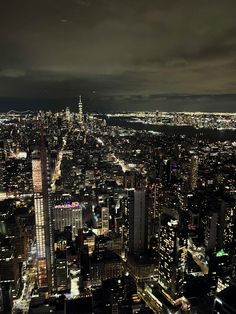 an aerial view of new york city at night from the top of the empire building