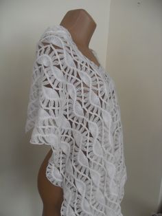 a white crochet top on a mannequin