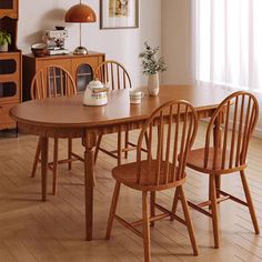 a dining room table with four chairs around it