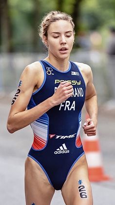 a woman in a swimsuit running on the street