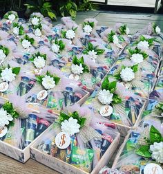 several boxes filled with different types of items on top of a wooden table next to plants