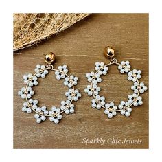 Beautiful Daisy Flowers 🌸  It is made with white glass pearls with gold plated round bead in the middle creating beautiful daisy flowers.  They are hoop earrings and they are about 2" inches long and hangs in a gold plated earstud and closes with a silicone stopper. The color intensity of the beads may vary slightly from what is shown due to computer monitor settings. If you would like multiple sets of this item to give as gifts, for your bridal party, or for any reason, please email me at spar Elegant White Flower Shaped Beaded Earrings, White Flower Charm Earrings, White Pearl Flower Earrings With Charm, Gold Daisy Earrings With Flower Charm, White Earrings With Flower Charm For Jewelry Making, White Flower-shaped Dainty Pearl Earrings, White Flower-shaped Pearl Earrings, White Pearl Drop Flower Earrings, White Pearl Earrings In Flower Shape