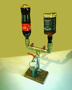 two beer kegs sitting next to each other on a wooden stand with a glass in front of them