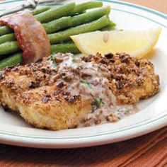 a white plate topped with meat and green beans