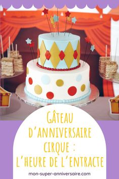 a birthday cake sitting on top of a table in front of a purple and yellow backdrop