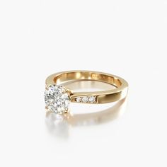 a yellow gold ring with a single diamond on the top and two diamonds on the bottom