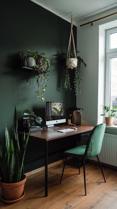 an office with green walls and plants on the desk