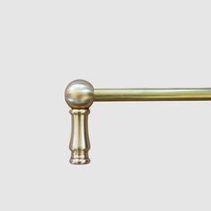 an image of a brass handle on a door knob or curtain rod with two handles