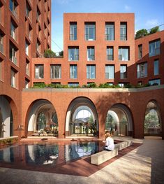 an artist's rendering of a courtyard with a pool in the foreground and large brick buildings on either side