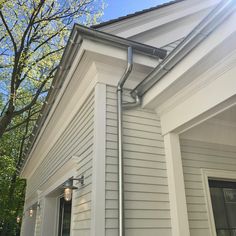 a gutter hose is attached to the side of a home's exterior wall