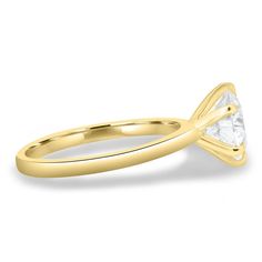 a yellow gold engagement ring with a princess cut diamond