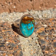 A stunning blue turquoise ring featuring a golden-brown matrix, complemented by a handmade sterling silver band with arrow stamping. This natural blue Royston turquoise exudes simple elegance. It features a sleek sterling silver band, perfect as a stacker ring, adorned with rare, vintage Nevada turquoise. A handcrafted piece, ideal for gifting. Size: 8.5. Stone: 10x15mm Weight: 4.9 grams. Sterling band: 4 mm wide. Hallmarked MSBOONE 925. Southwestern Chrysocolla Gemstone Rings, Southwestern Chrysocolla Turquoise Ring, Southwestern Turquoise Chrysocolla Ring, Southwestern Sterling Silver Rings With Large Stone, Southwestern Sterling Silver Ring With Large Stone, Southwestern Sterling Silver Opal Ring, Southwestern Turquoise Ring In Sterling Silver, Southwestern Style Turquoise Gemstone Ring In Sterling Silver, Untreated Southwestern Turquoise Sterling Silver Ring