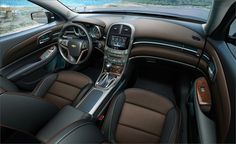 the interior of a car with brown and black leather trims, steering wheel and dashboard