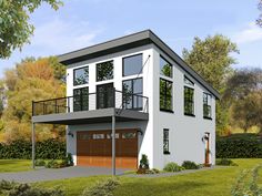 a three story house with two garages on the second floor