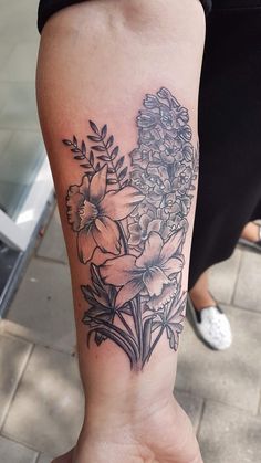 a woman's arm with flowers on it