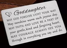 a card saying goddaughter may god forever light your way on the back of a wooden box