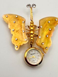 BONETTO Watch Gold Tone Metal Rhinestone Butterfly Dangle Watch Mother Of Pearl Wings and Face Rhinestone Numbers Brooch Watch. Battery not included. Face Rhinestones, Watch Battery, Gold Tone Metal, Gold Watch, Mother Of Pearl, Brooch Pin, Favorite Jewelry, Brooches, Gold Tones