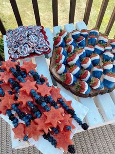 patriotic desserts are displayed on wooden trays