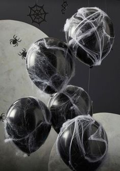 black and white balloons with spider web on them